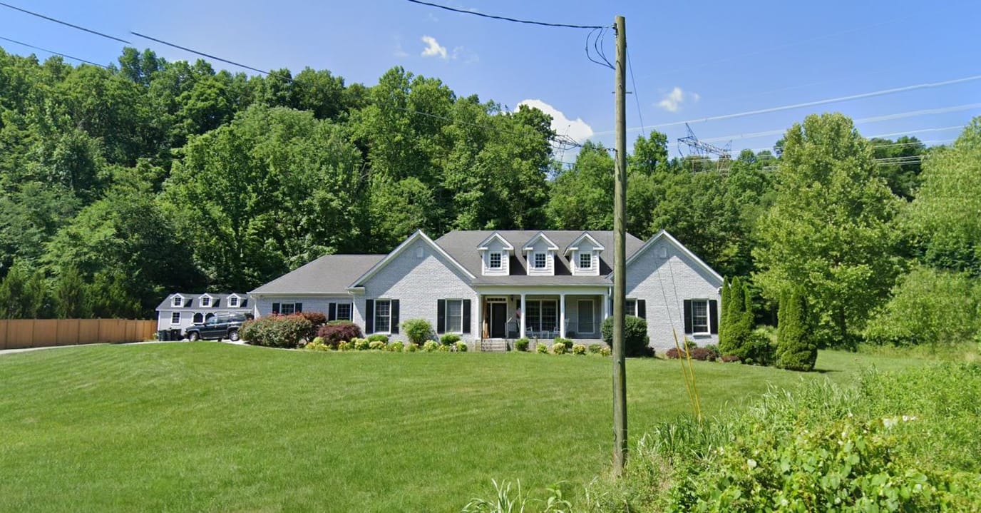 Exterior view of Harpeth Manor with landscaped lawn