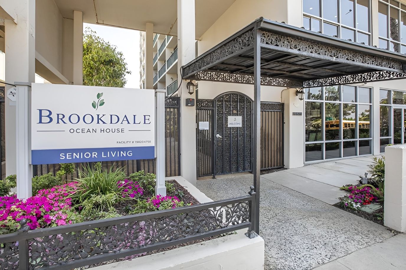 Entrance to Brookdale Ocean House with flowers and signage