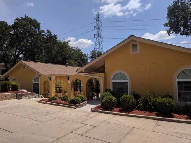 Exterior view of a yellow assisted living facility