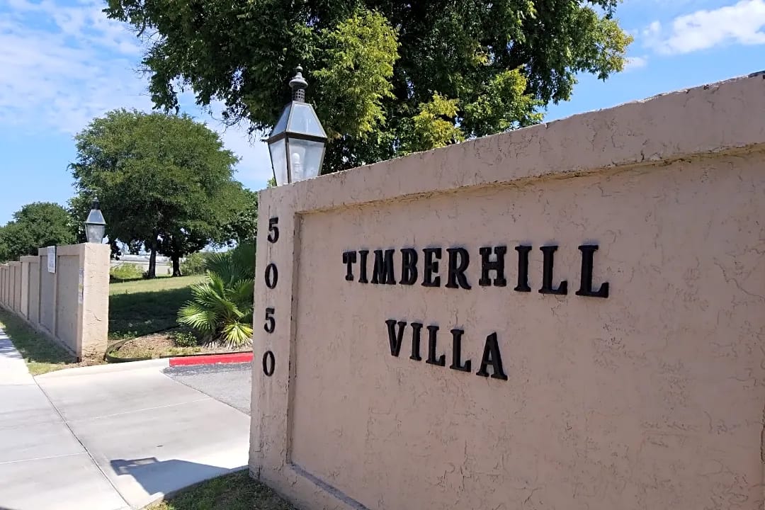 Exterior view of Timberhill Villa entrance and sign