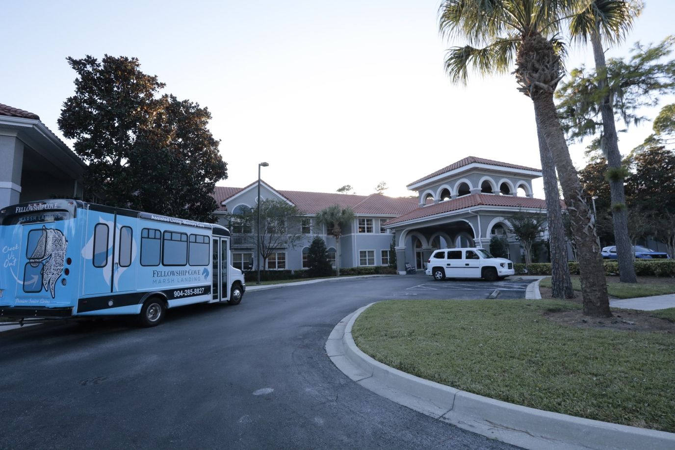 Exterior view of The Cove at Marsh Landing with facility vehicles