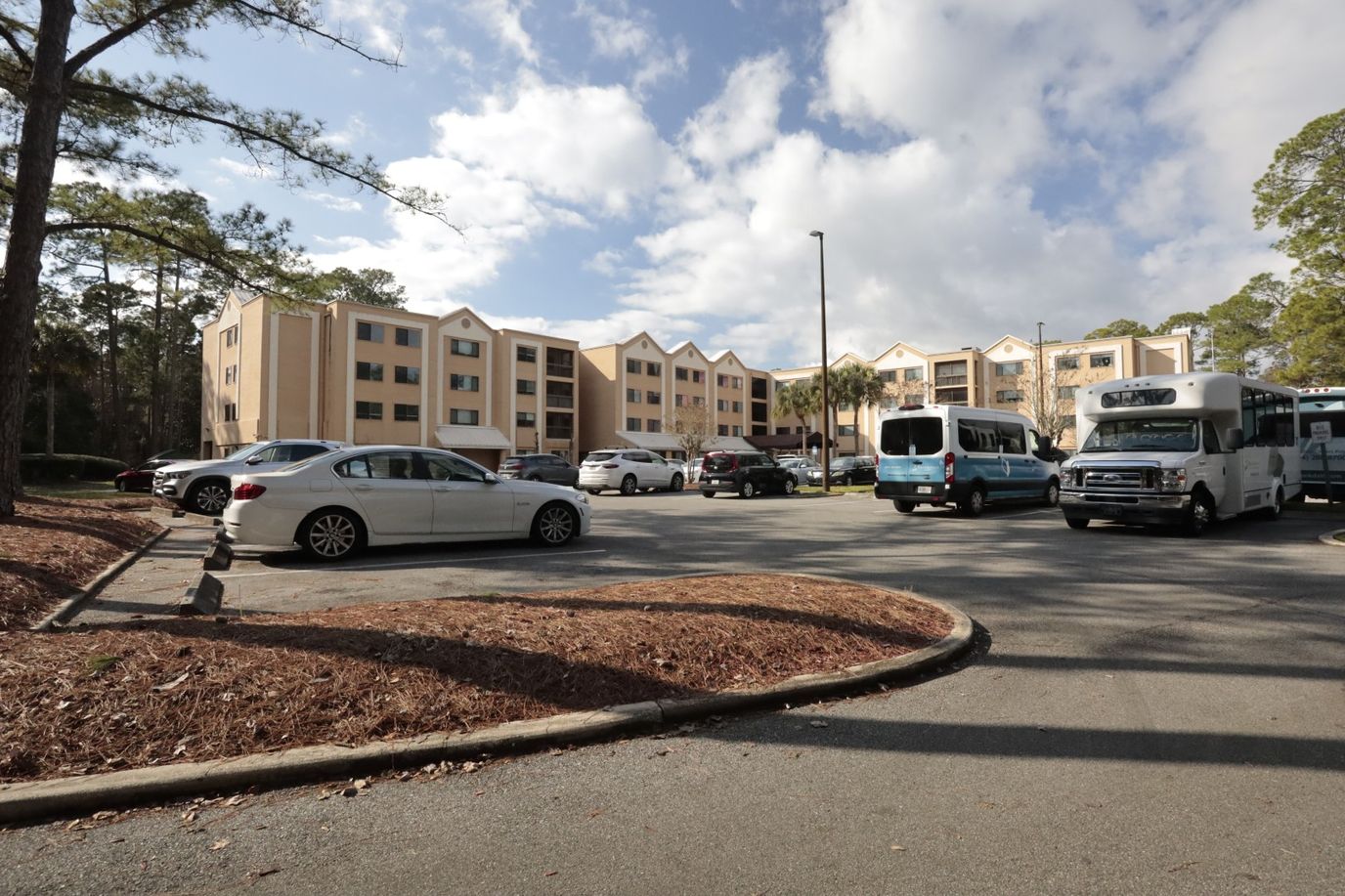 Exterior view of a senior living facility parking lot and building