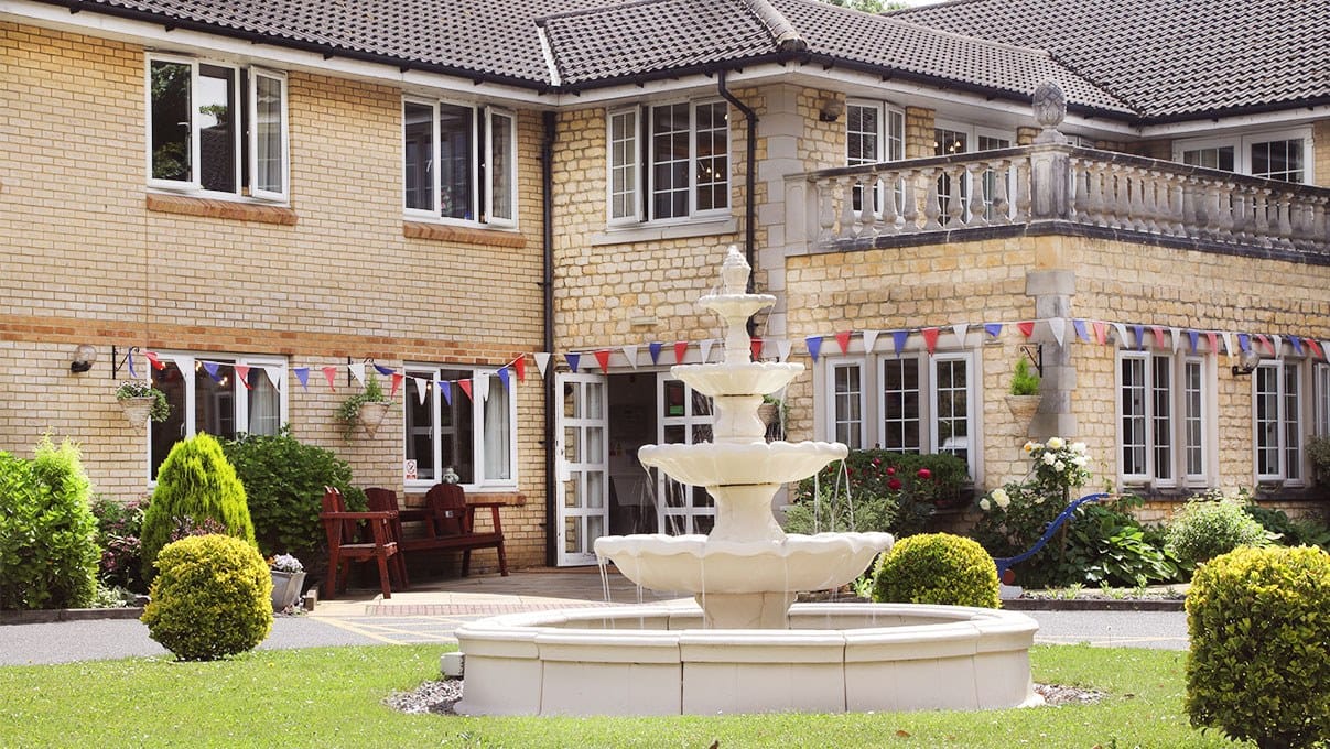 Exterior view of Ashlynn Grange Care Home with fountain