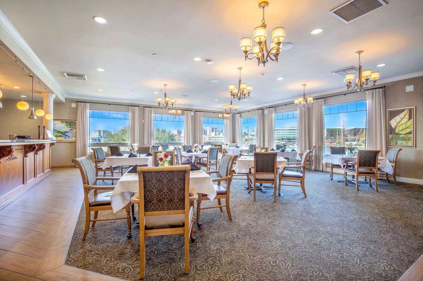 Elegant dining room with tables set for residents