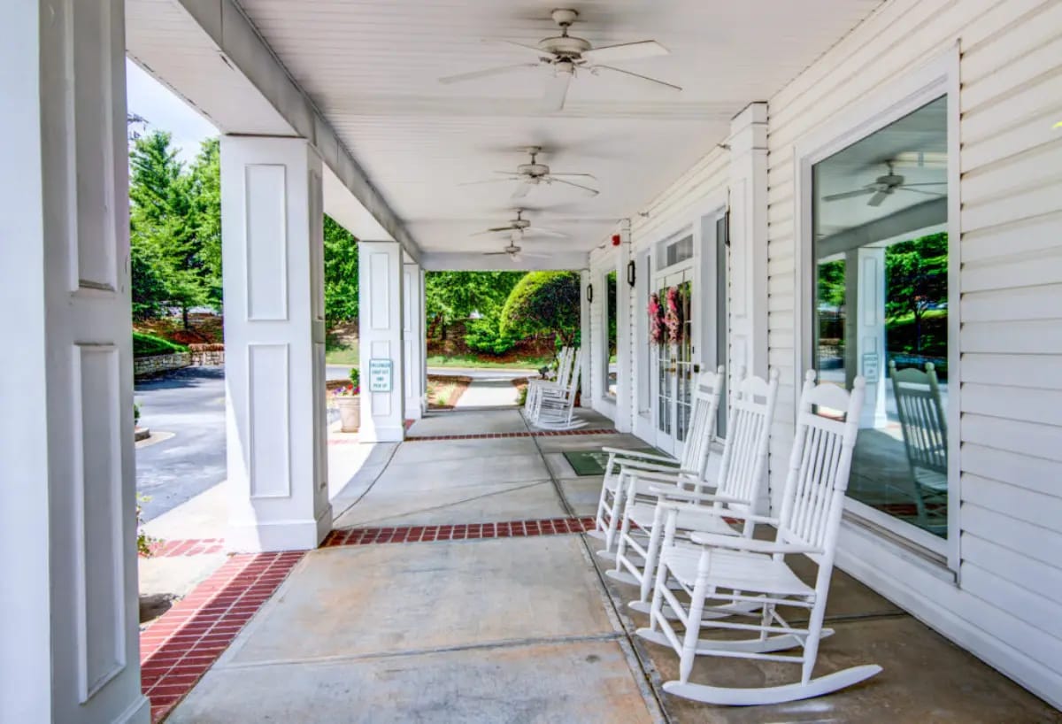Exterior view of a porch with rocking chairs
