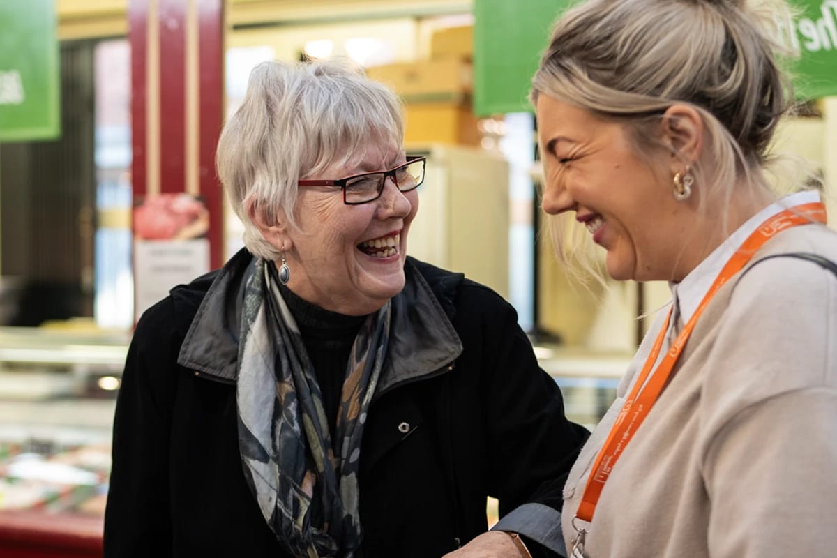 Two women laughing in a friendly interaction
