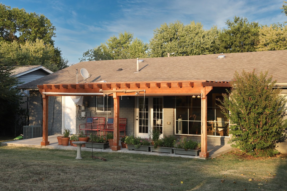 Exterior view of a building with a patio and garden area