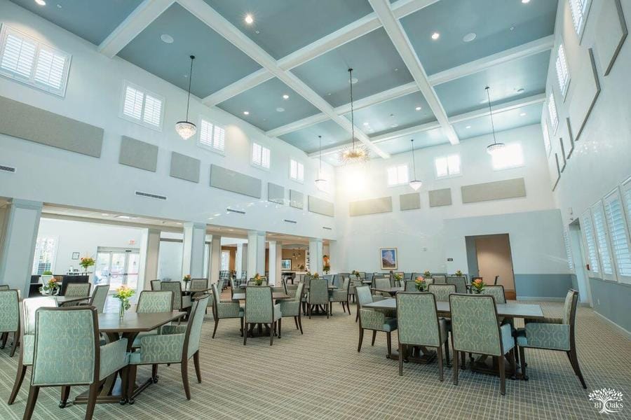 Spacious dining room with tables and floral centerpieces