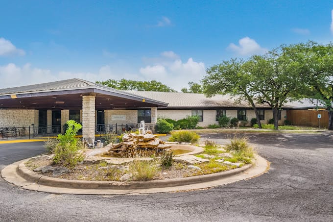 Exterior view of Deer Creek Nursing and Rehab with landscaping