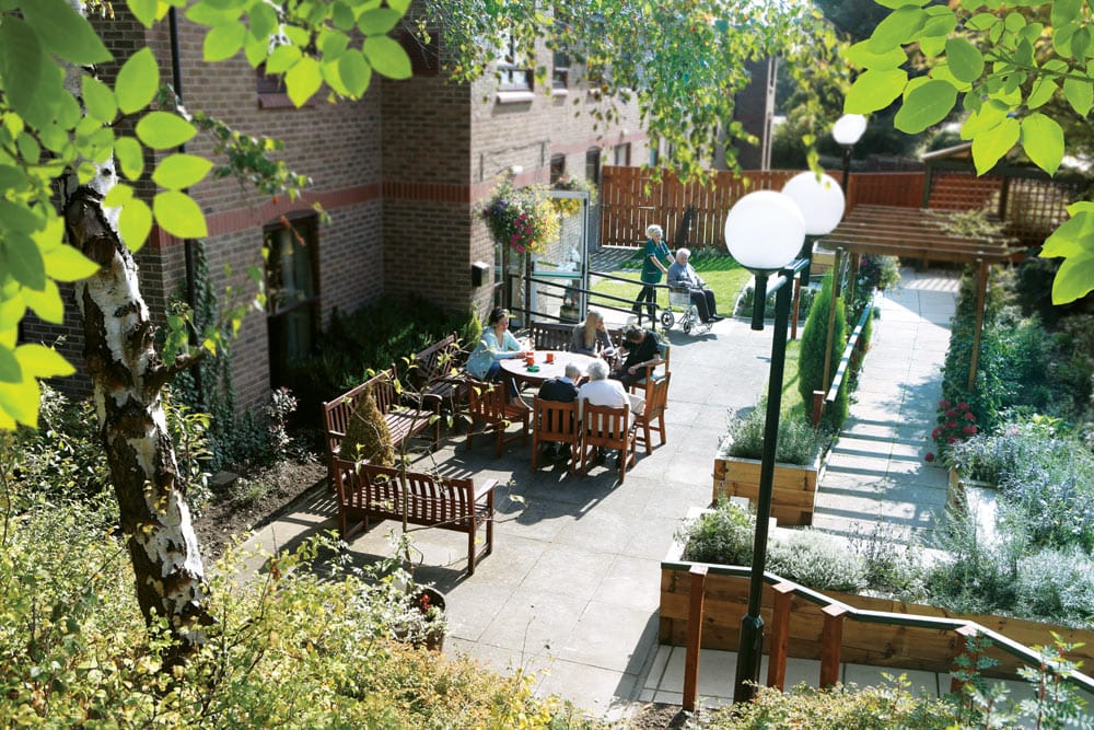 Residents enjoying time in an outdoor space with seating.