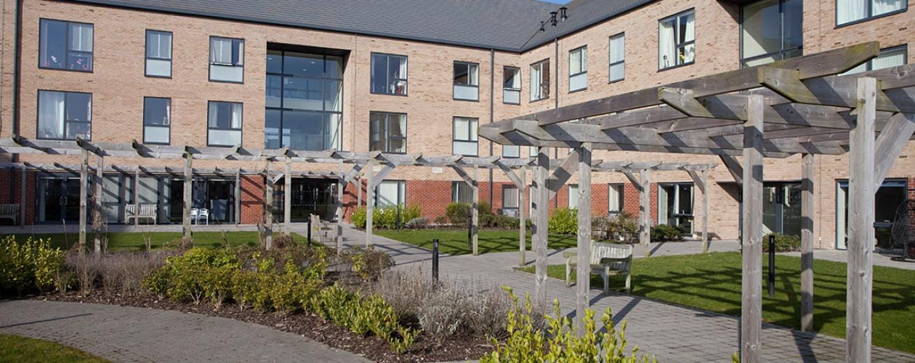Outdoor courtyard area with seating and gardens
