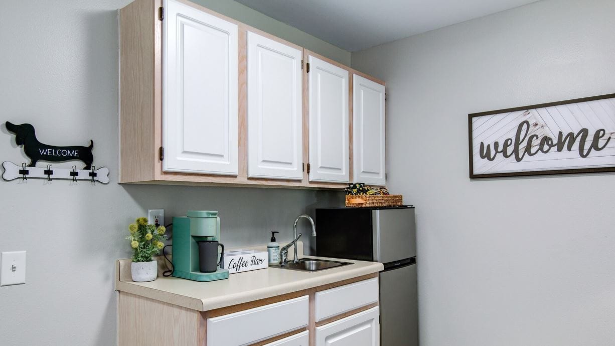 Bright kitchen area with modern decor and coffee station