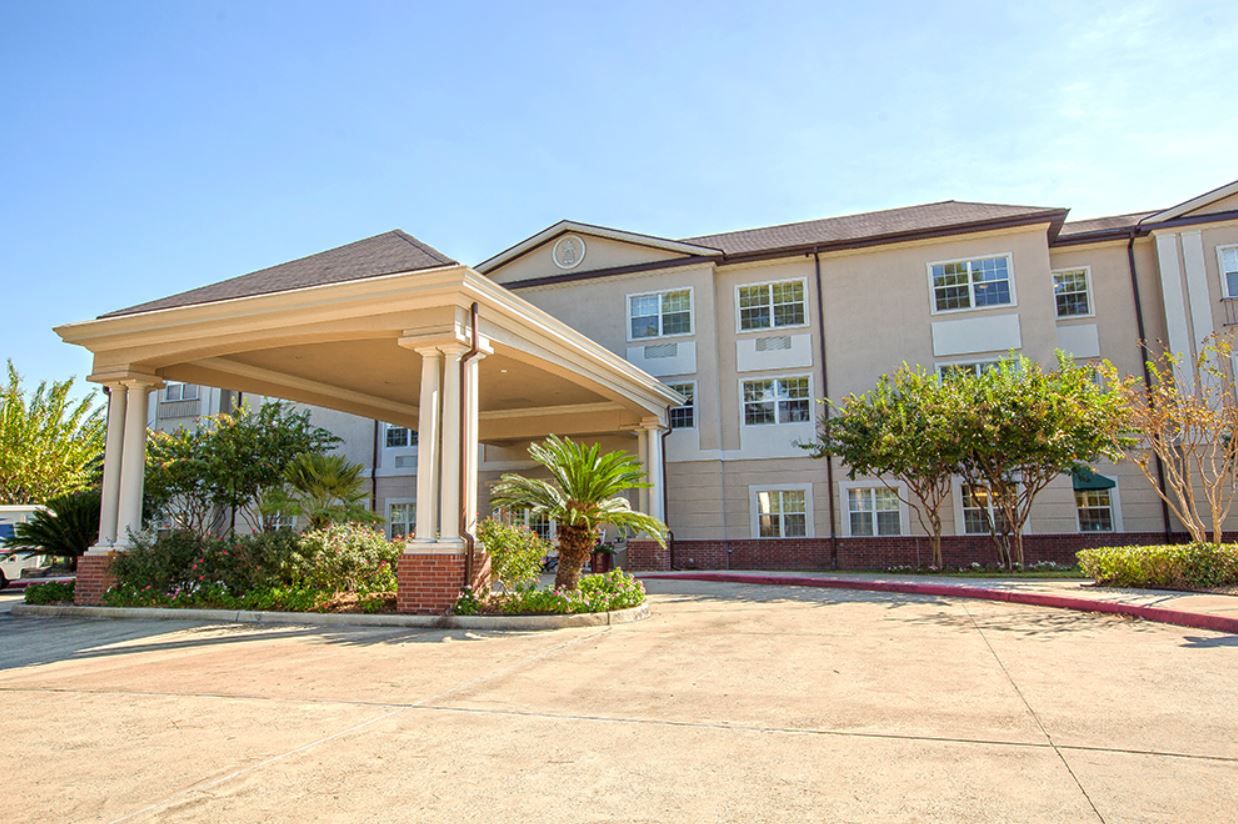 Exterior view of Brookdale Cypress Station with landscaped entrance
