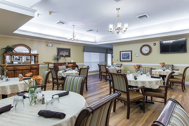 Dining room with tables set for residents