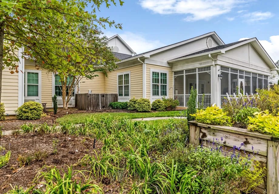 Exterior view of a senior living facility with gardens