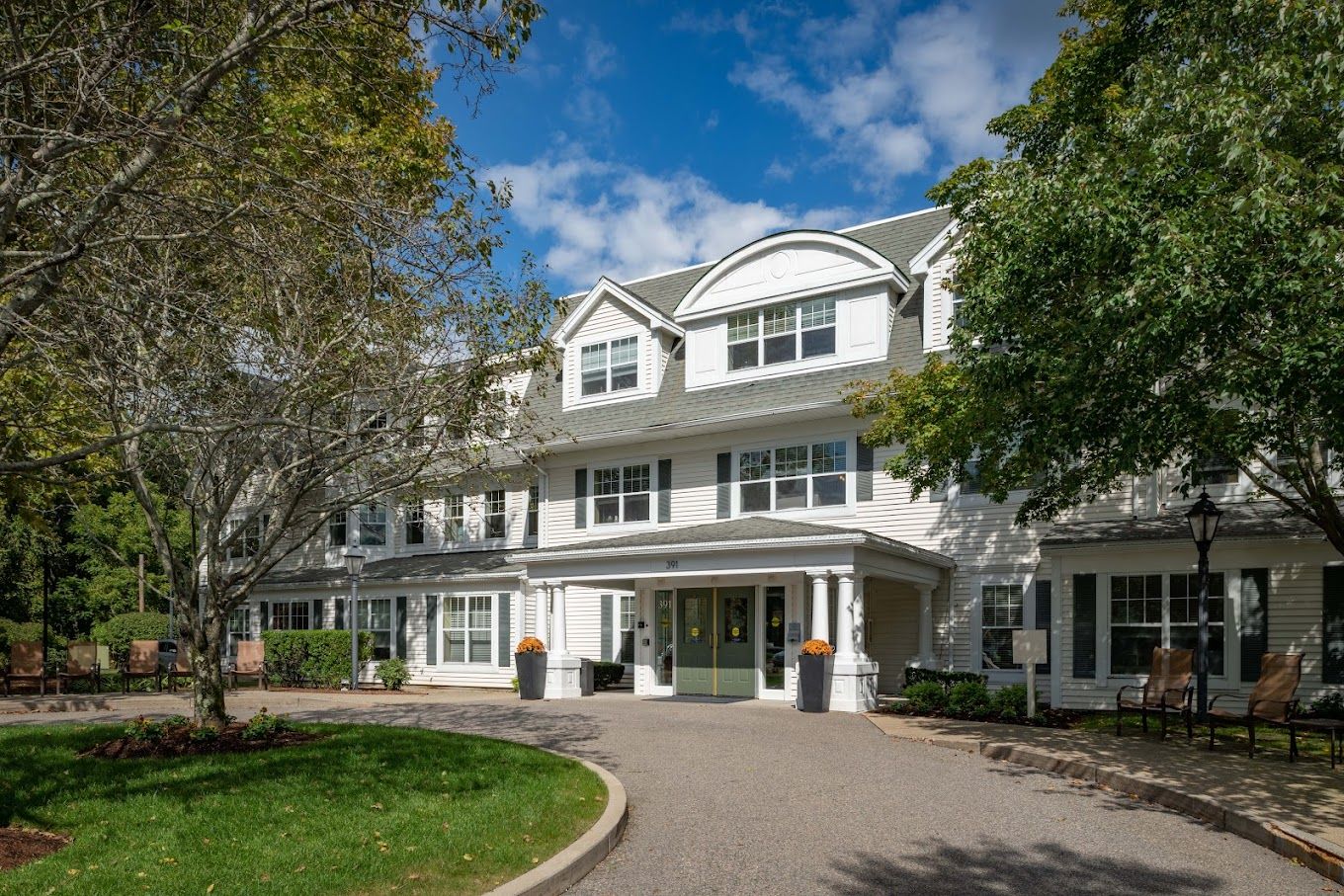 Exterior view of Charter Senior Living of Dedham with landscaped garden