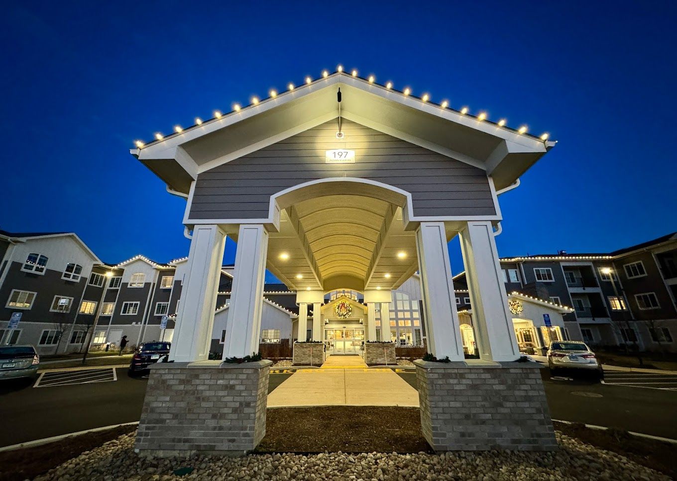 Entrance of Charter Senior Living at dusk with lights