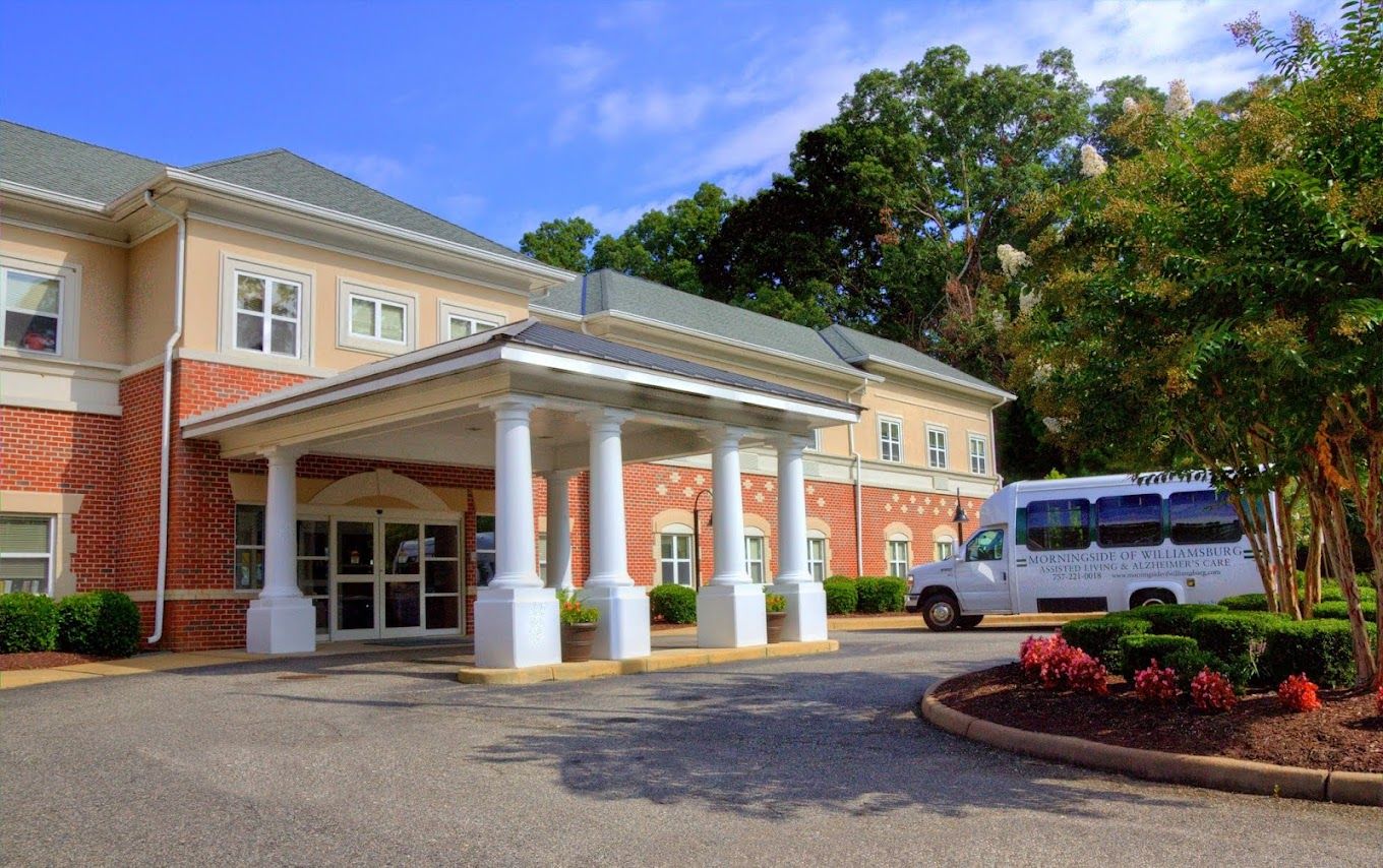 Exterior view of Charter Senior Living entrance and van
