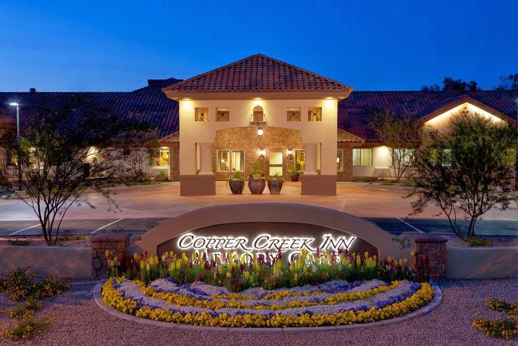 Exterior view of Copper Creek Inn Memory Care at dusk