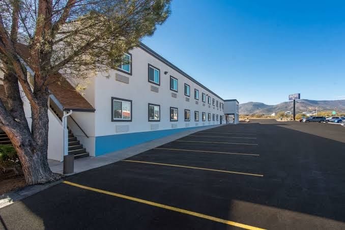 Exterior view of a facility building with parking