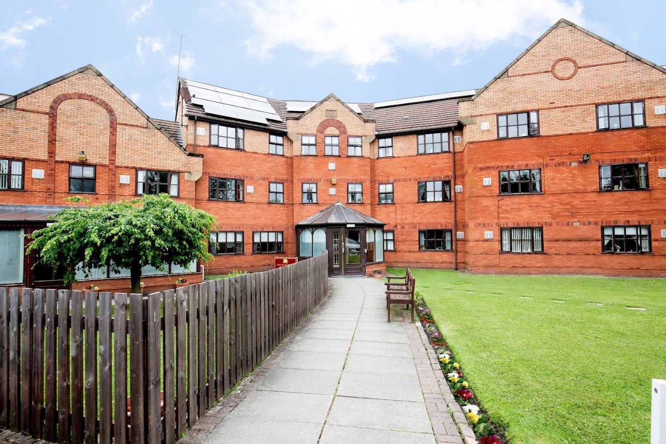 Exterior view of Dovehaven Care Homes with gardens and pathways