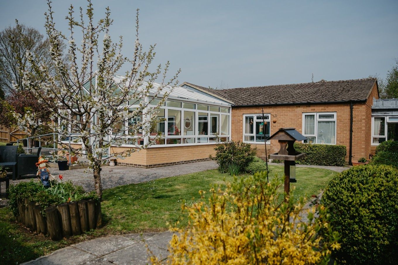 Exterior view of Edgehill Care Home surrounded by greenery