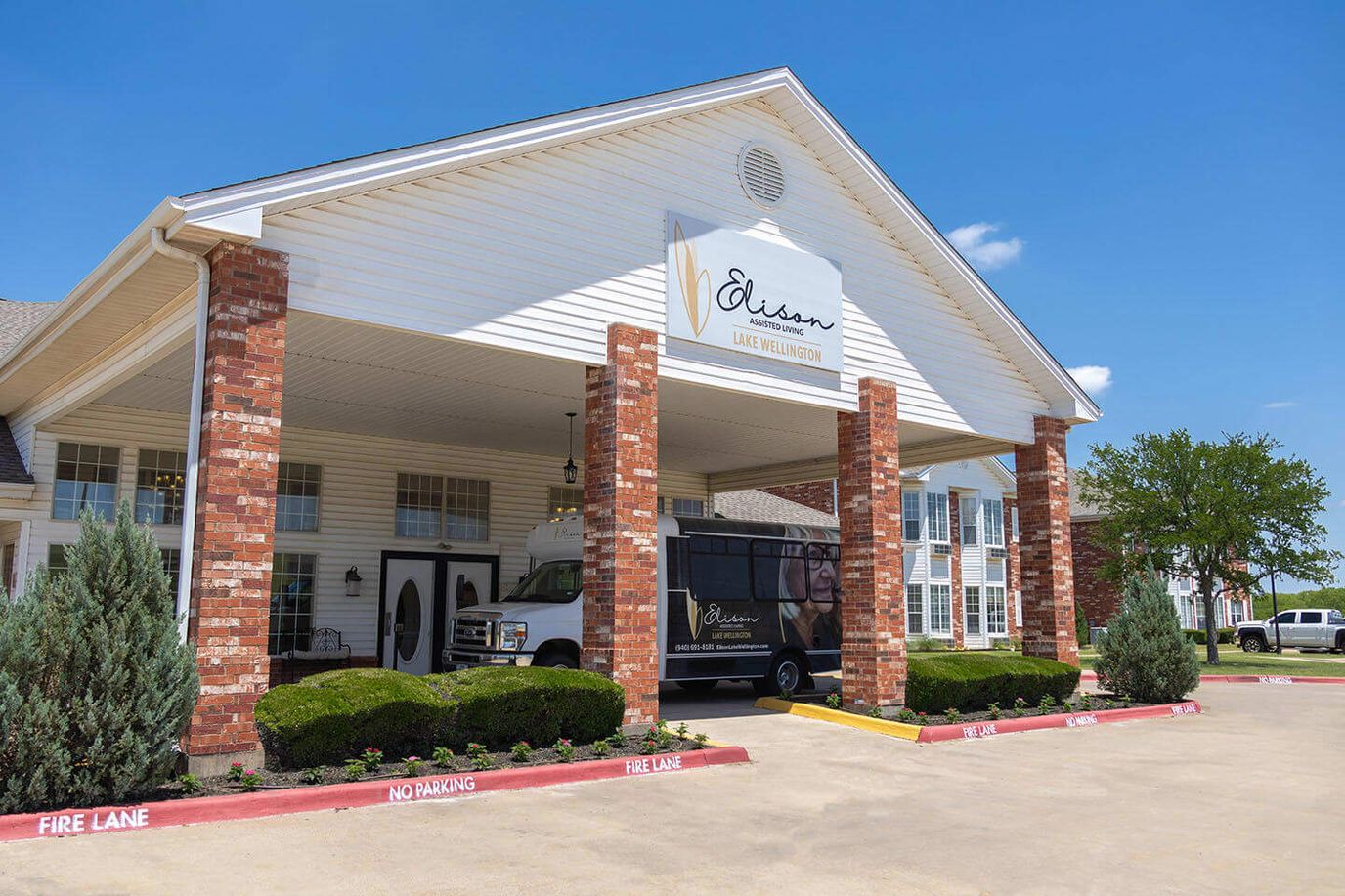 Exterior view of Elison Assisted Living with transportation van