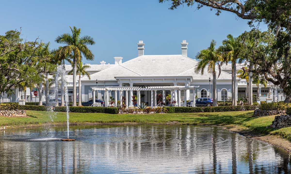 Exterior view of Heron Point with pond and landscaping