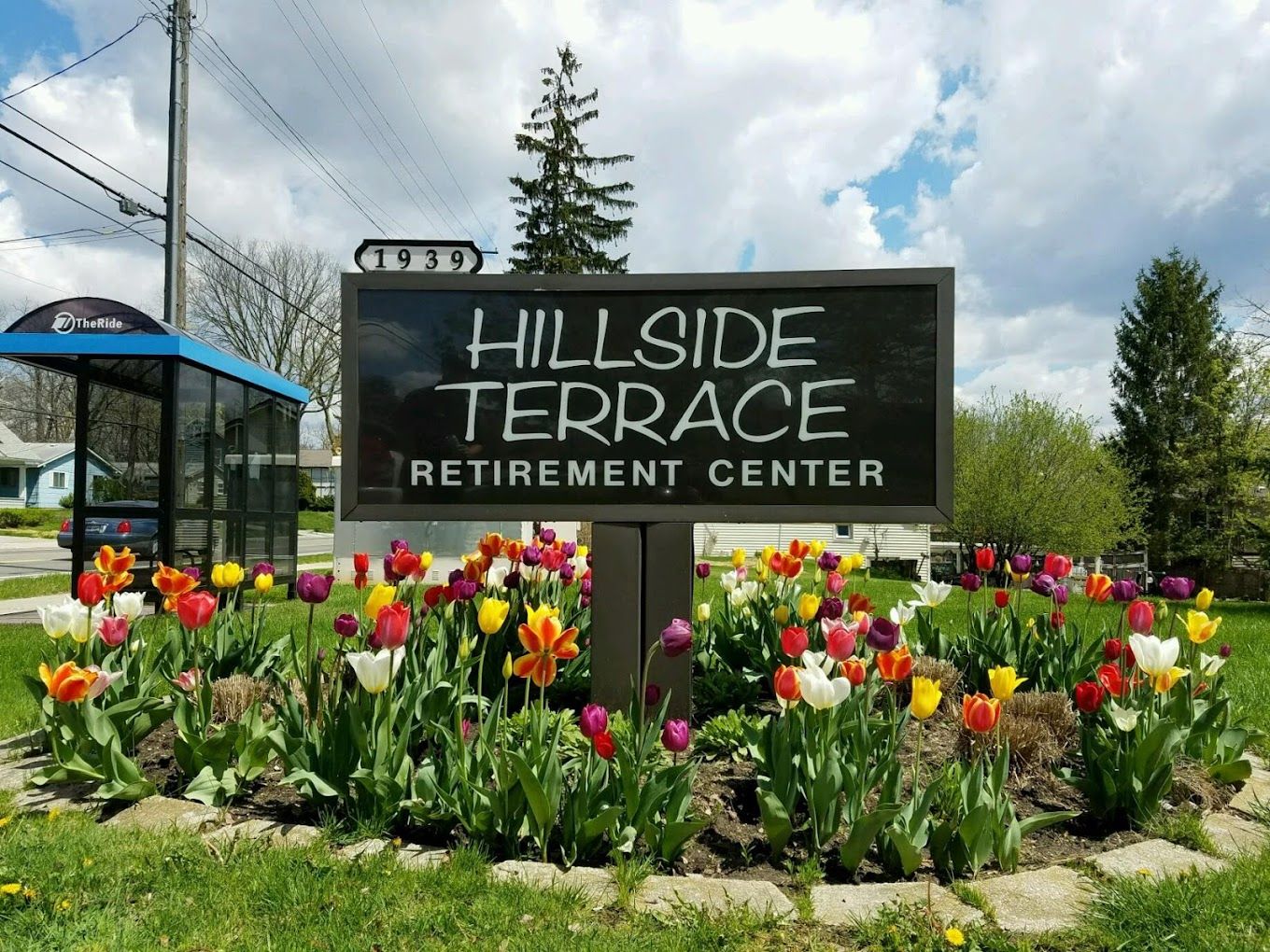 Sign for Hillside Terrace Retirement Center surrounded by flowers