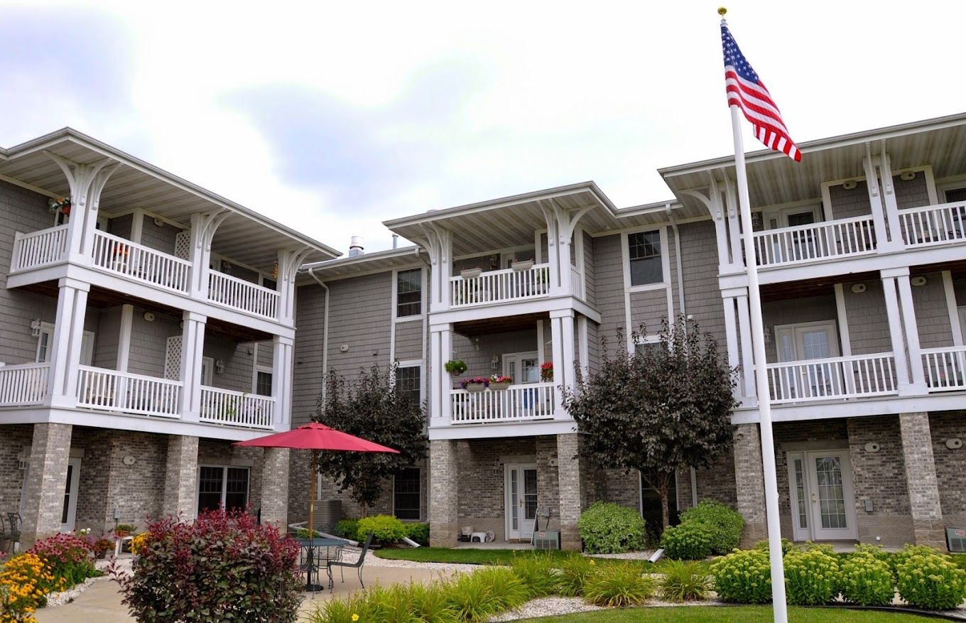 Exterior view of a senior living facility with gardens