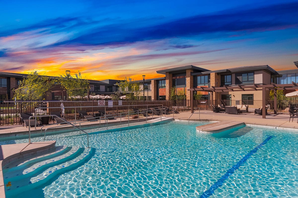 Swimming pool area with sunset sky