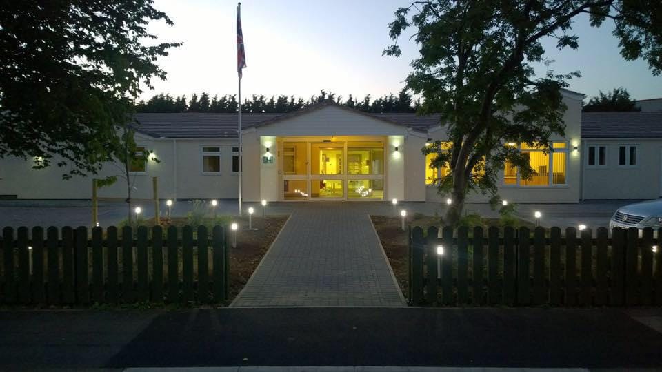Exterior view of Orchard Manor View at dusk