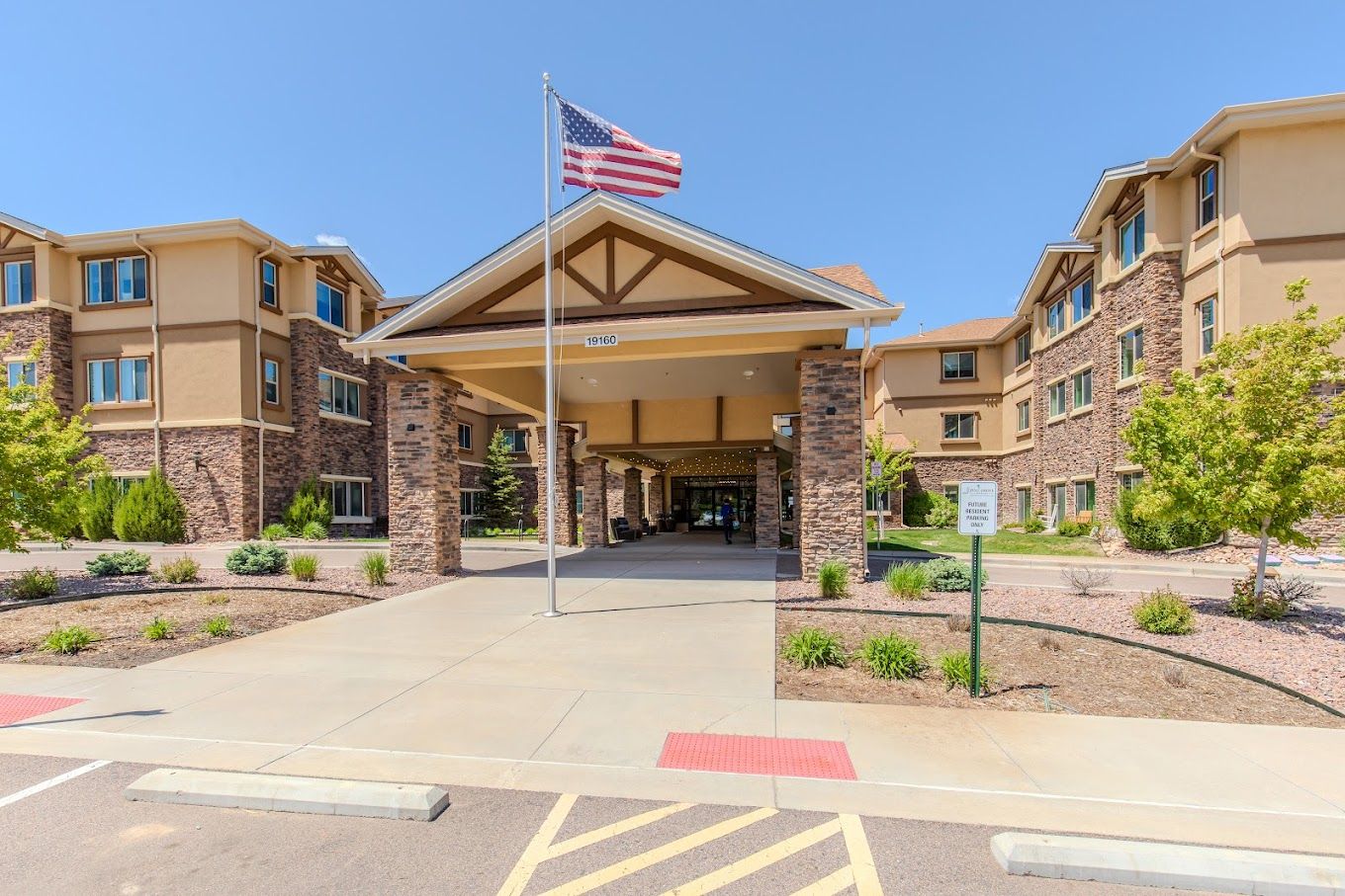 Front entrance of a senior living facility with landscaping