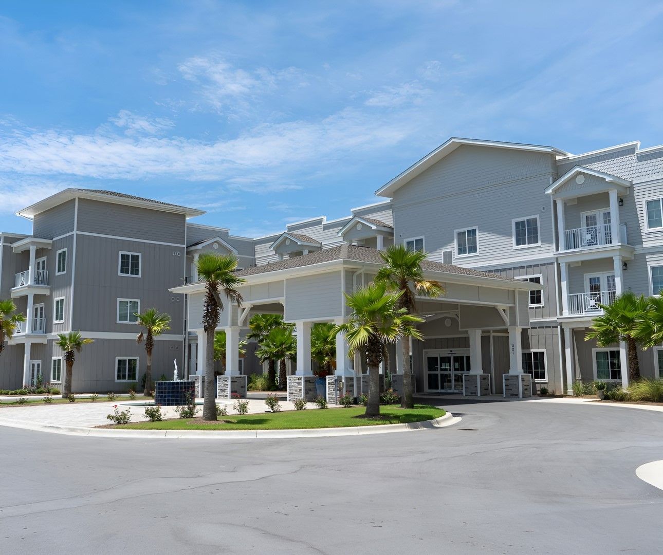 Exterior view of Seagrass Village building with palm trees