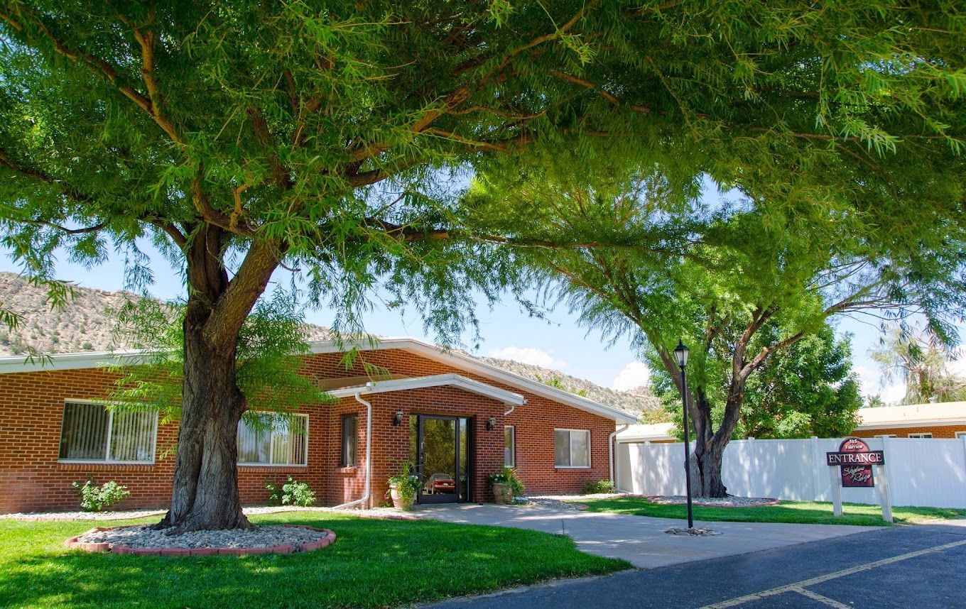 Exterior view of Skyline Ridge Skilled Nursing with trees and entrance