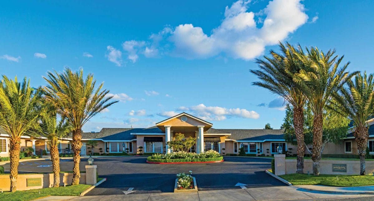 Exterior view of Sterling Commons facility surrounded by palm trees