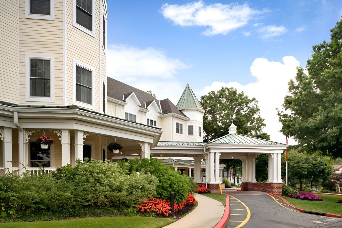Exterior view of the senior living facility entrance with gardens