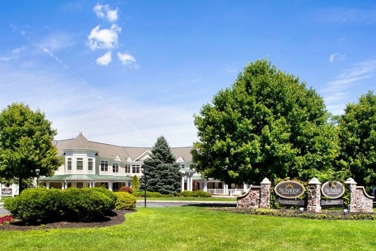 Exterior view of Sunrise of Madison facility with landscaped gardens