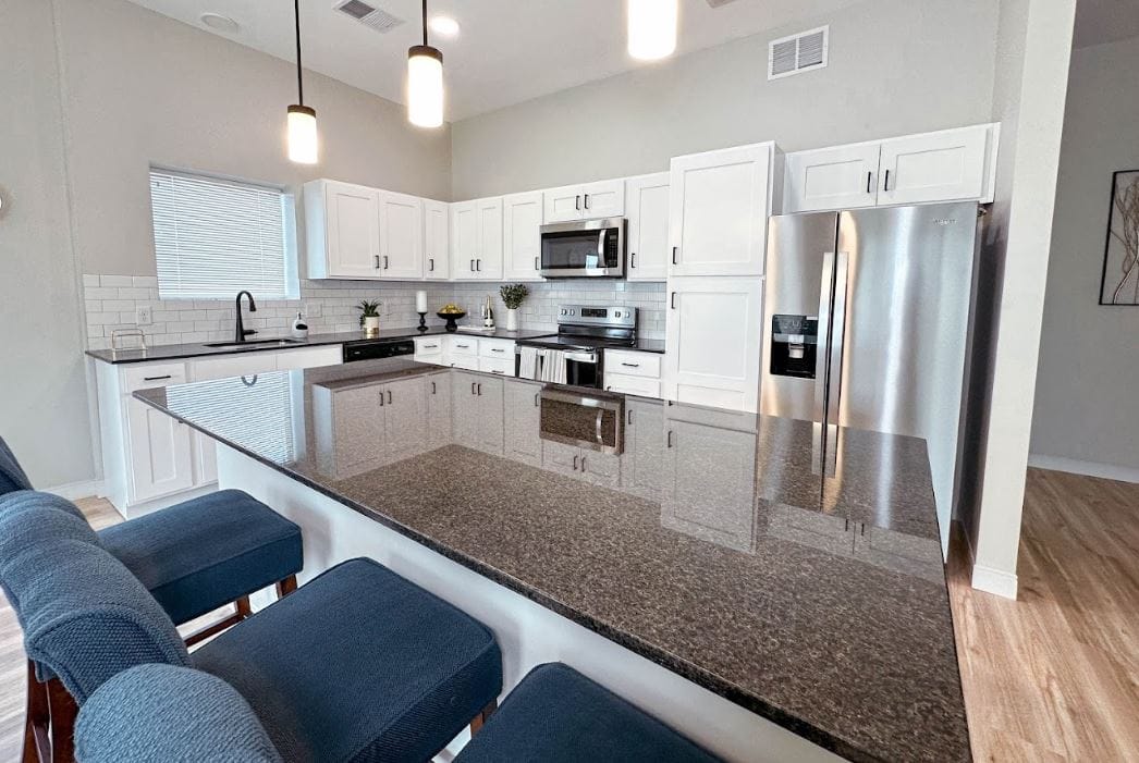 A modern kitchen interior with granite countertops