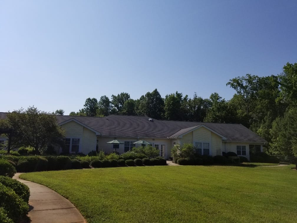 Exterior view of a senior living facility with lush landscaping