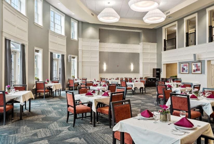Elegant dining room setup with tables and flowers