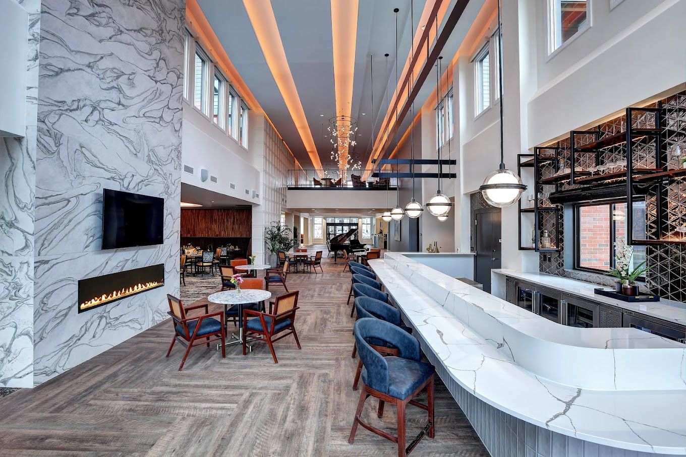 Bright and modern common area with seating and fireplace