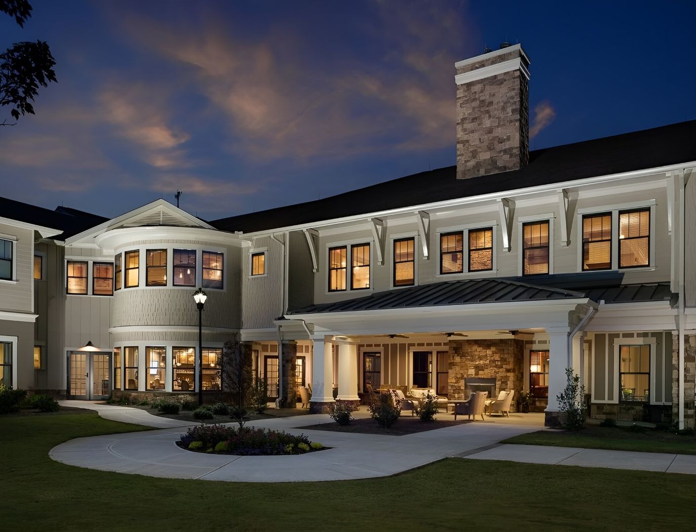 Exterior view of a senior living facility at dusk