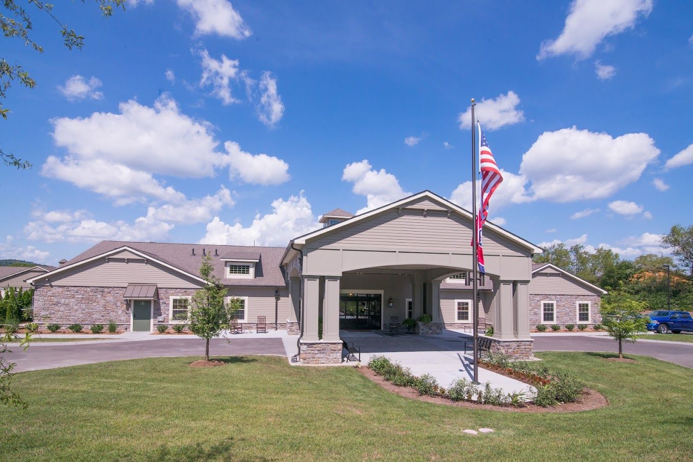 Exterior view of a senior living facility with flags