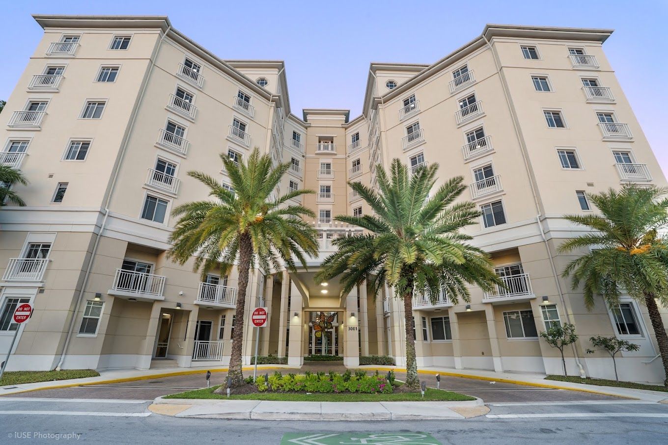 Front entrance of The Meridian at Waterways with palm trees
