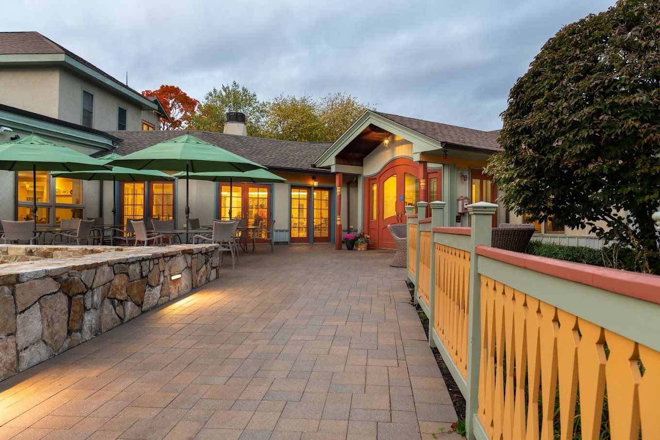 Exterior view of a senior living facility with outdoor seating