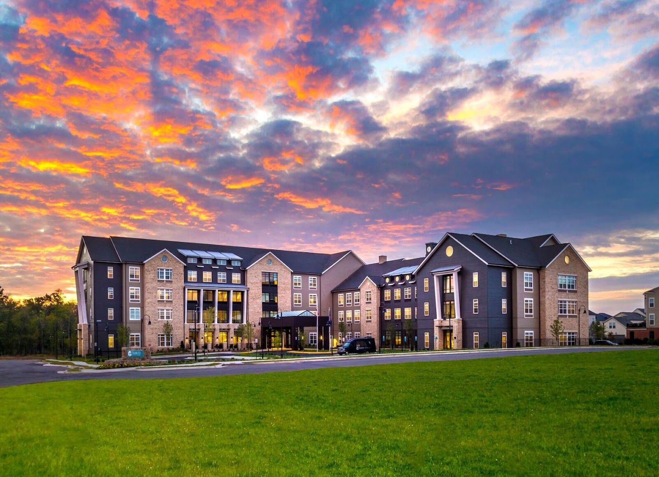 Beautiful exterior of Tribute at One Loudoun against a sunset