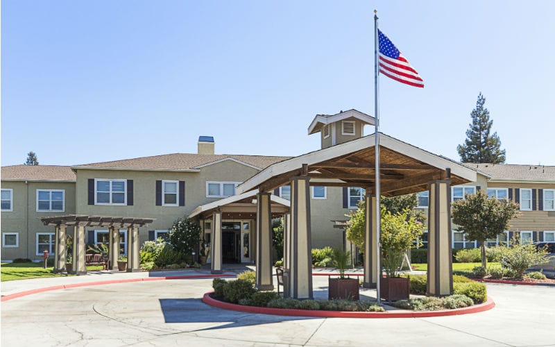 Exterior view of Truewood by Merrill with flag and entrance