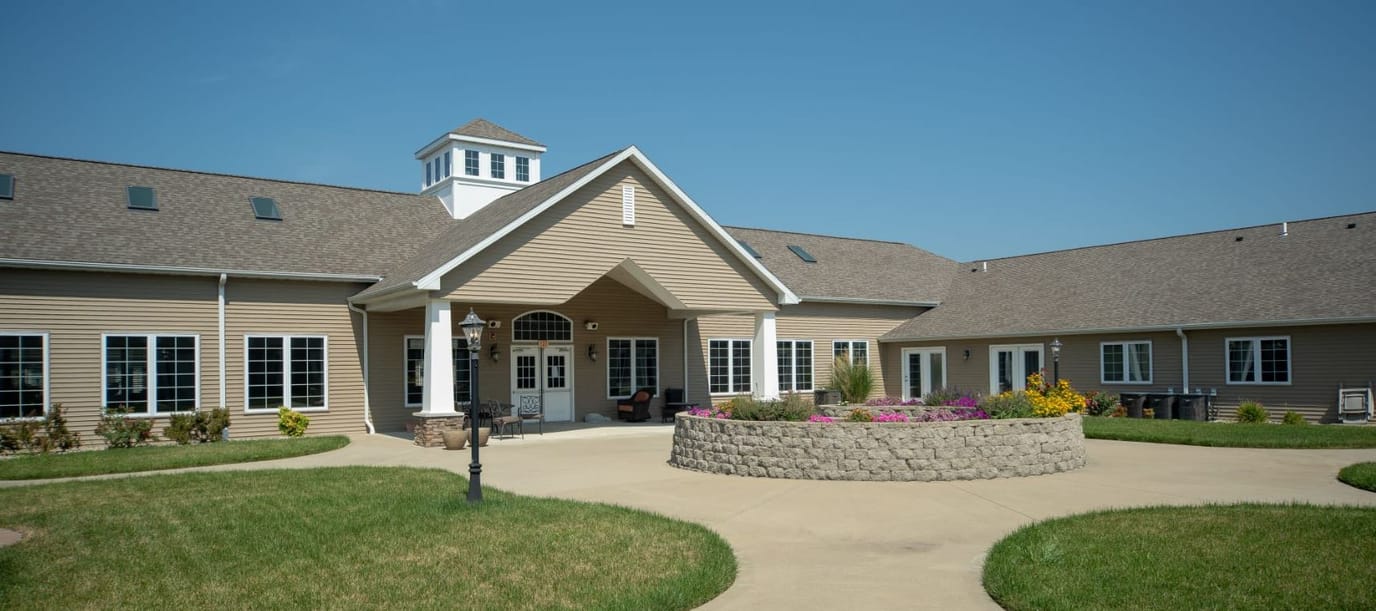 Exterior view of a senior living facility with garden