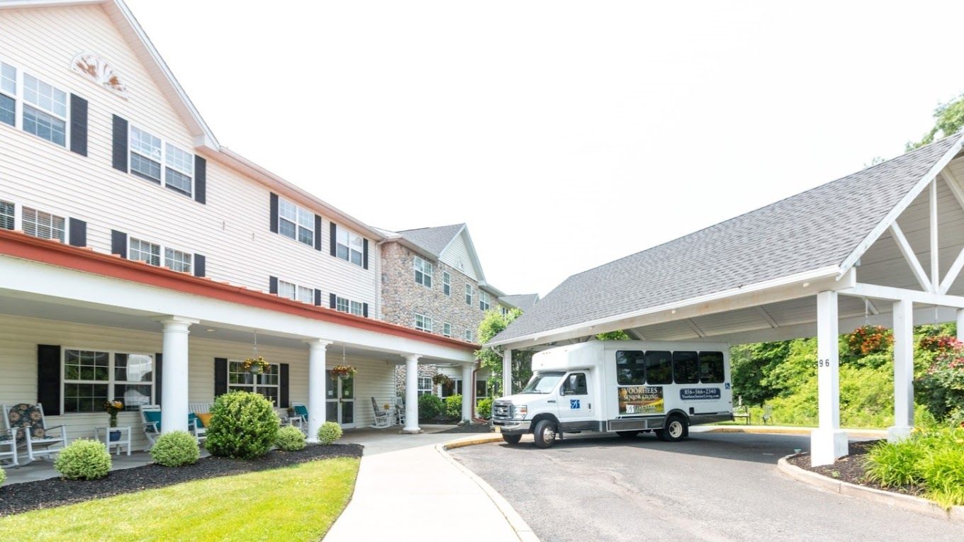Exterior view of assisted living facility with shuttle bus